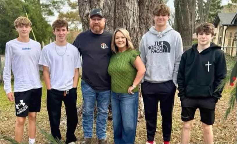 The T. Rowe family standing together in their yard in East Texas